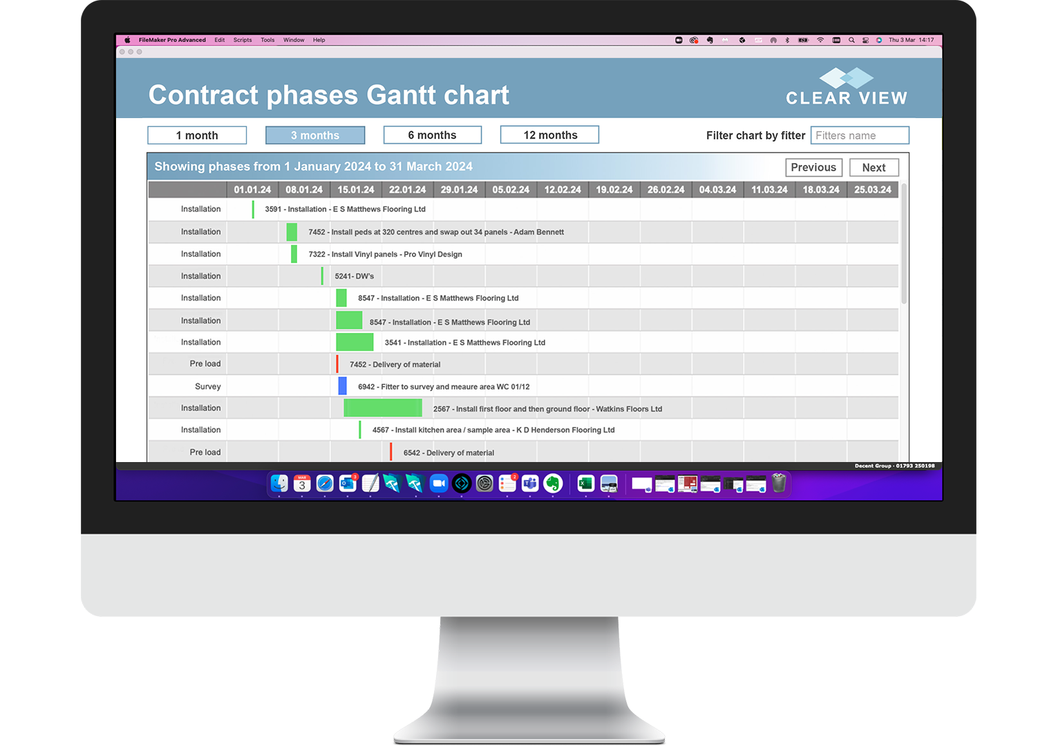 A large desktop monitor showing a Gantt chart created by a Decent Group business system